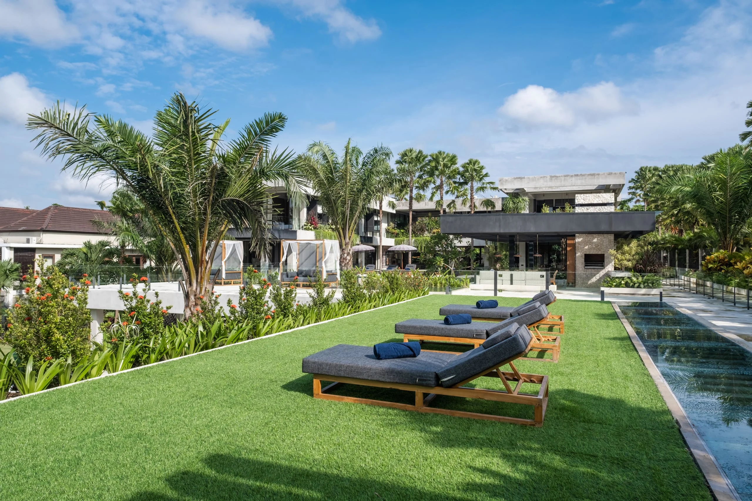 Sunlit terraces, palms and pools at The V House