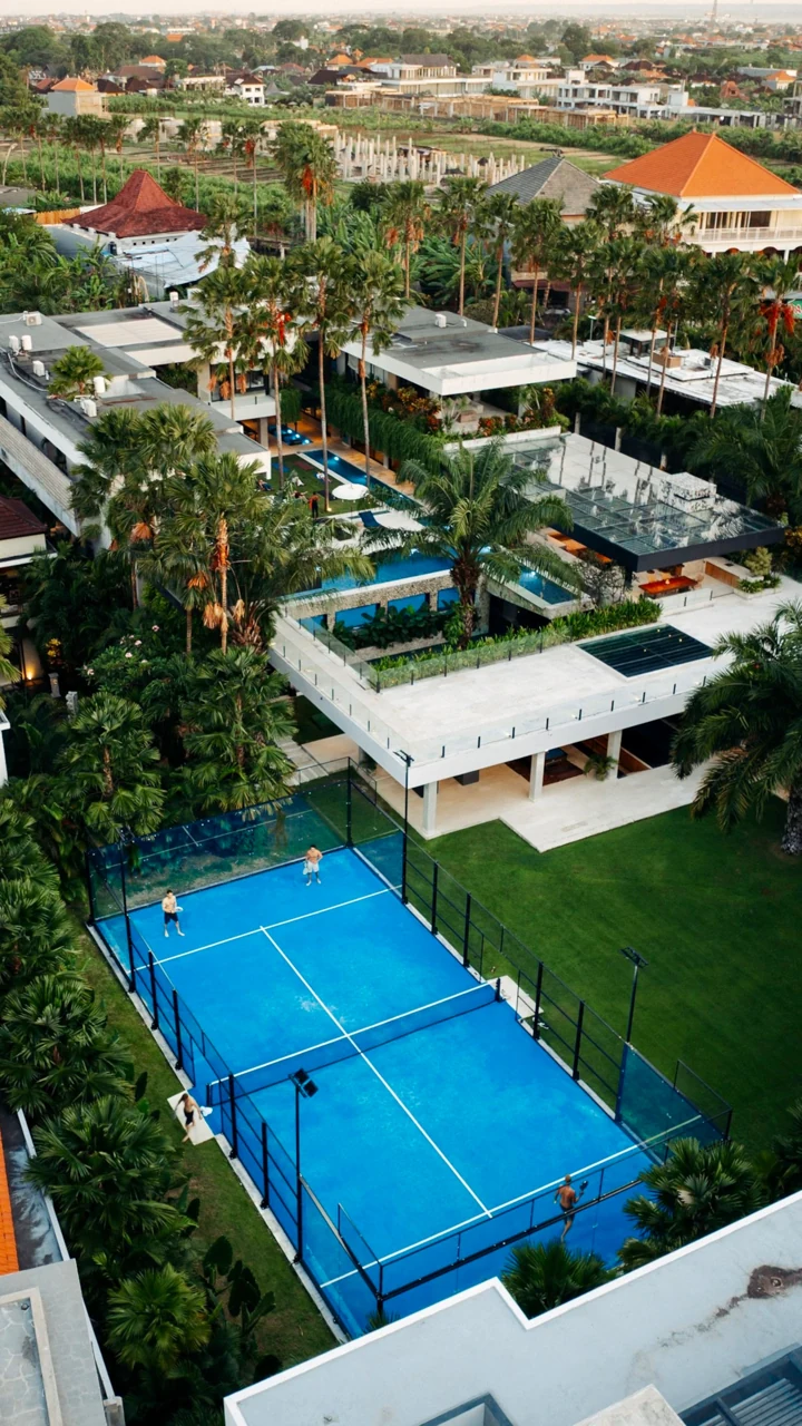 Aerial view of the blue padel court and white pavilion