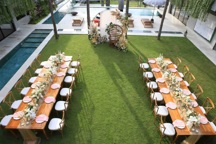 Long tables arranged on the lawn for a private gathering